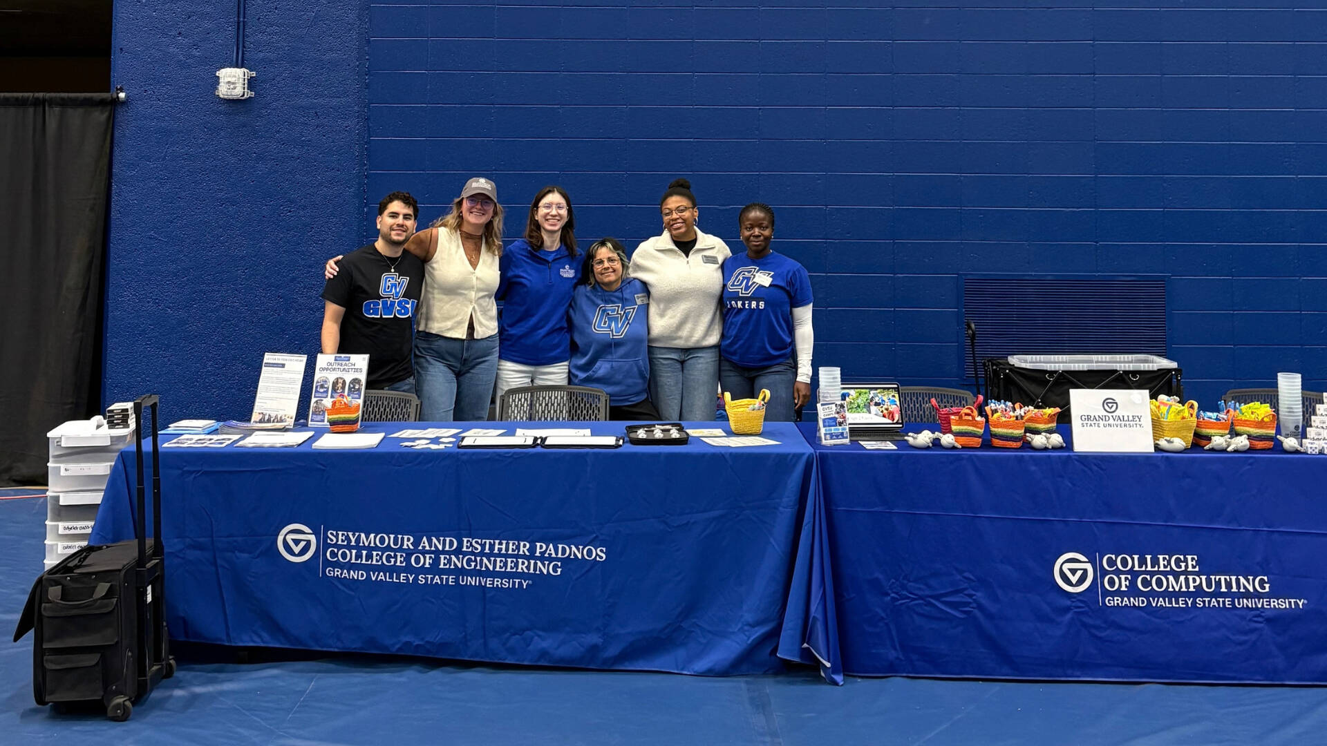 A group of GVSU staff and students representing the college of computing at an outreach event.